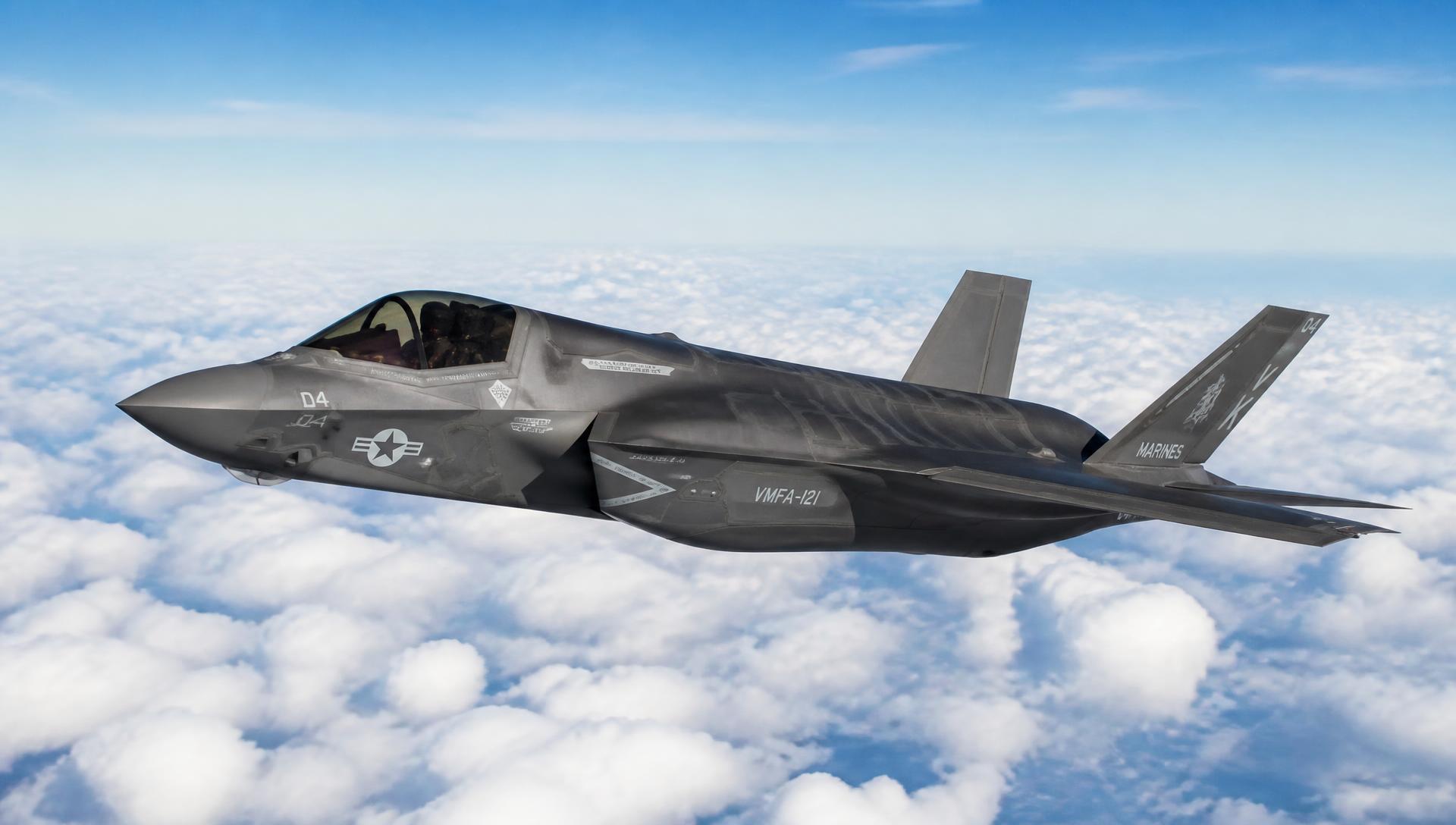 F-35 Lightning II in high-speed flight above a cloud deck